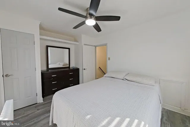 a bedroom with a bed and a dresser