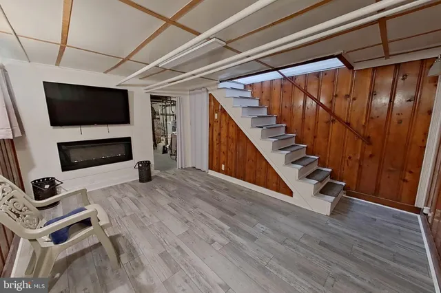 a view of a livingroom with furniture and a flat screen tv