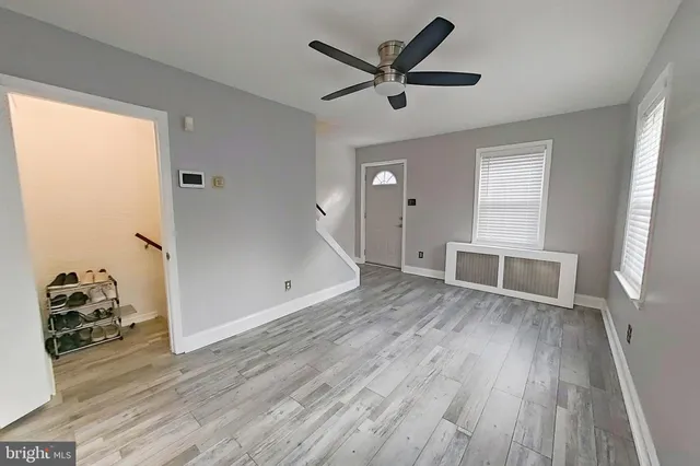 a view of a livingroom with wooden floor and a window
