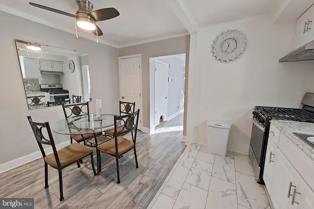a dining room with a wooden table and chairs