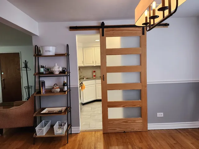 a view of a bedroom with workspace and window