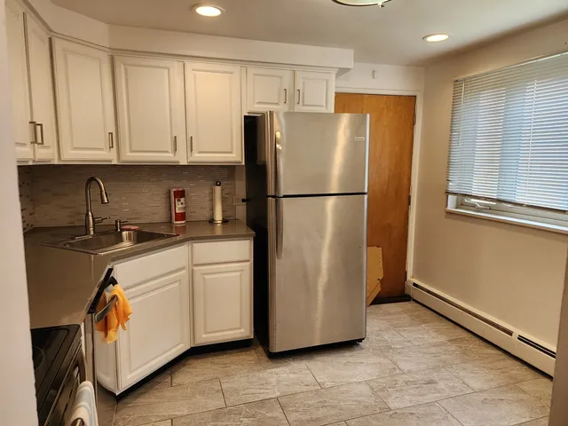 a white refrigerator freezer sitting in a kitchen
