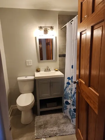 a bathroom with a sink toilet and mirror
