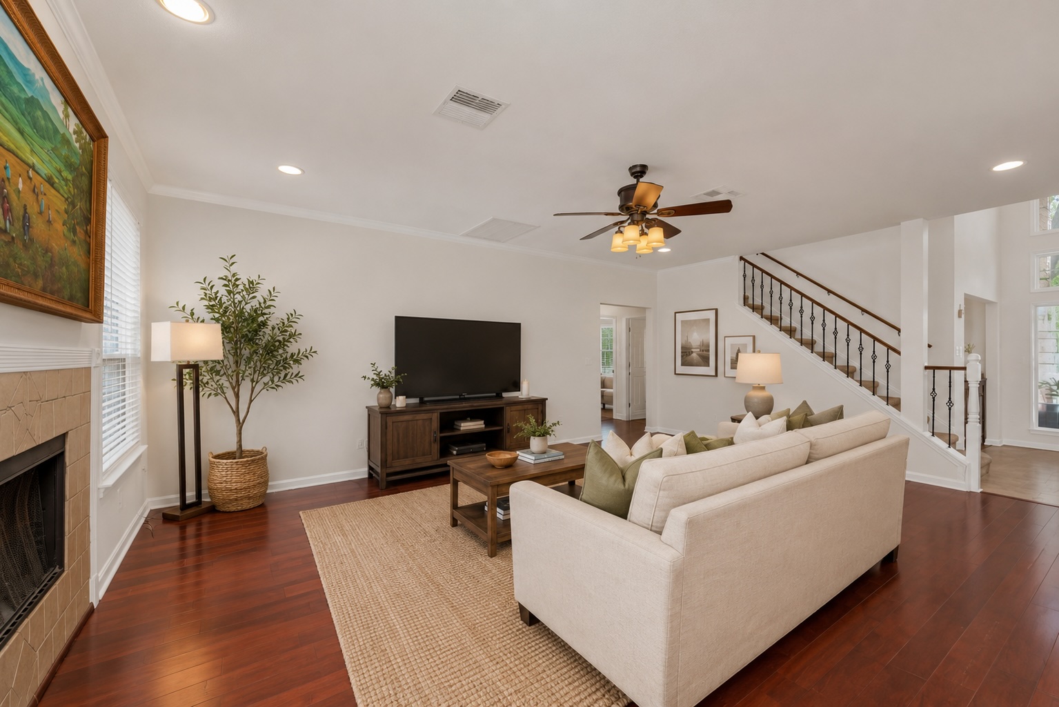 12528 Labrador Cove Austin, TX 78729 - Photo 6 of 40 Virtually Staged | Spacious family room featuring rich hardwood flooring, fireplace, open-concept design, and designer-inspired furnishings that showcase the room’s exceptional comfort, scale, and entertaining potential. Furnishings shown are for visualization purposes only.