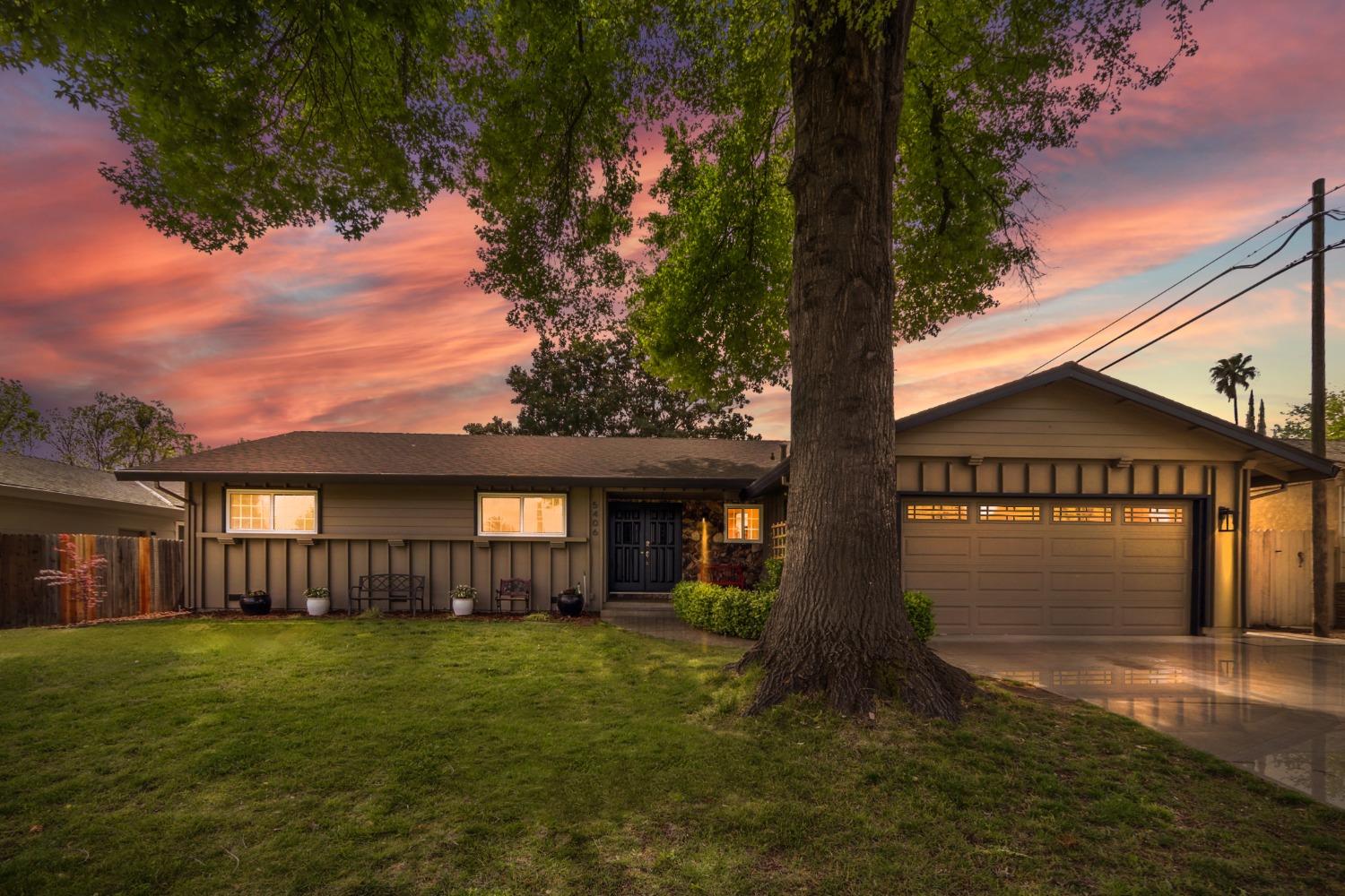a front view of a house with a garden