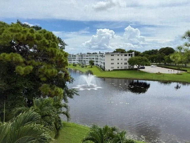 a view of a lake with houses in back