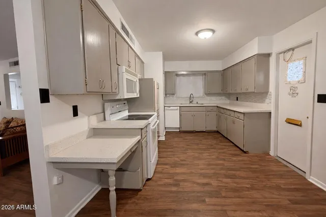 a kitchen with stainless steel appliances granite countertop a sink a stove and a refrigerator