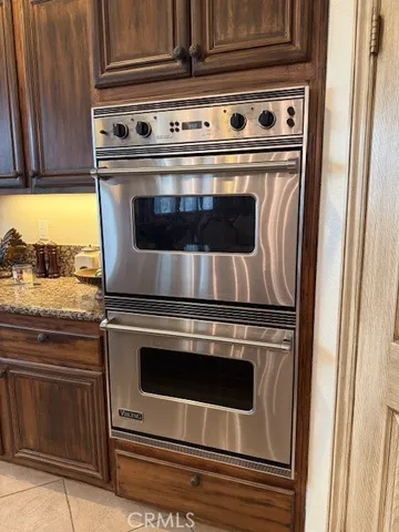 a kitchen with stainless steel appliances granite countertop a sink and a stove