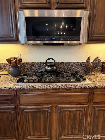 a living room with furniture a flat screen tv and a large window