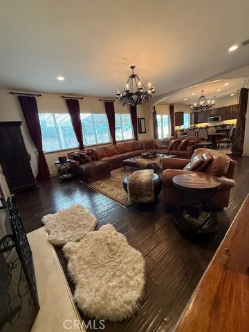 a living room with furniture and a chandelier