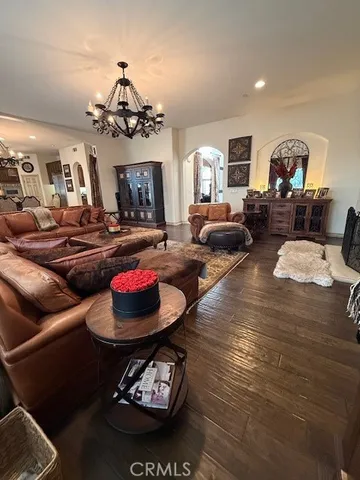 a bedroom with a bed a dresser and a large mirror