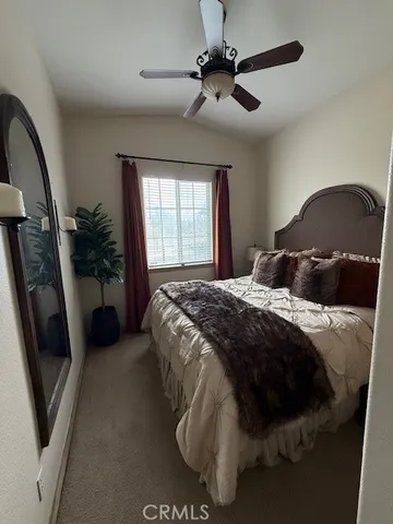 a bedroom with a bed and a large mirror