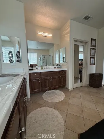 a bed sitting in a bedroom and chandelier