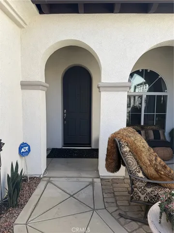 a balcony with table and chairs