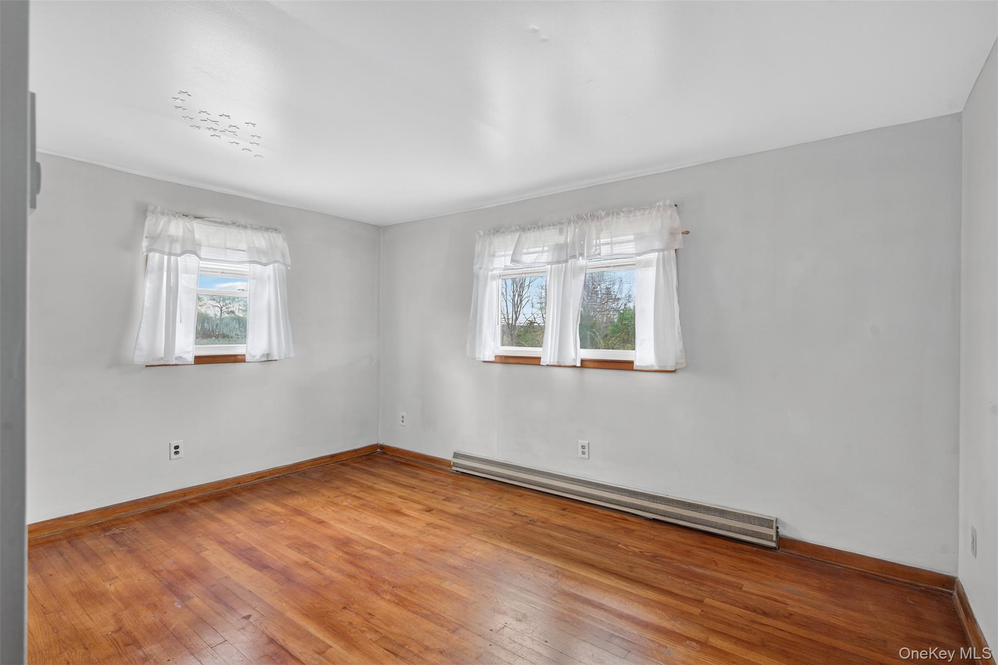 4030 Highway 209, Unit 4028 Stone Ridge, NY 12484 - Photo 15 of 22 a view of a room with wooden floor and windows
