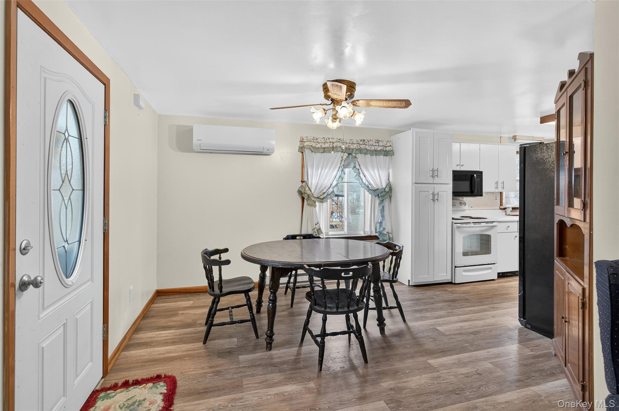 4030 Highway 209, Unit 4028 Stone Ridge, NY 12484 - Photo 6 of 22 a view of a dining room with furniture and wooden floor