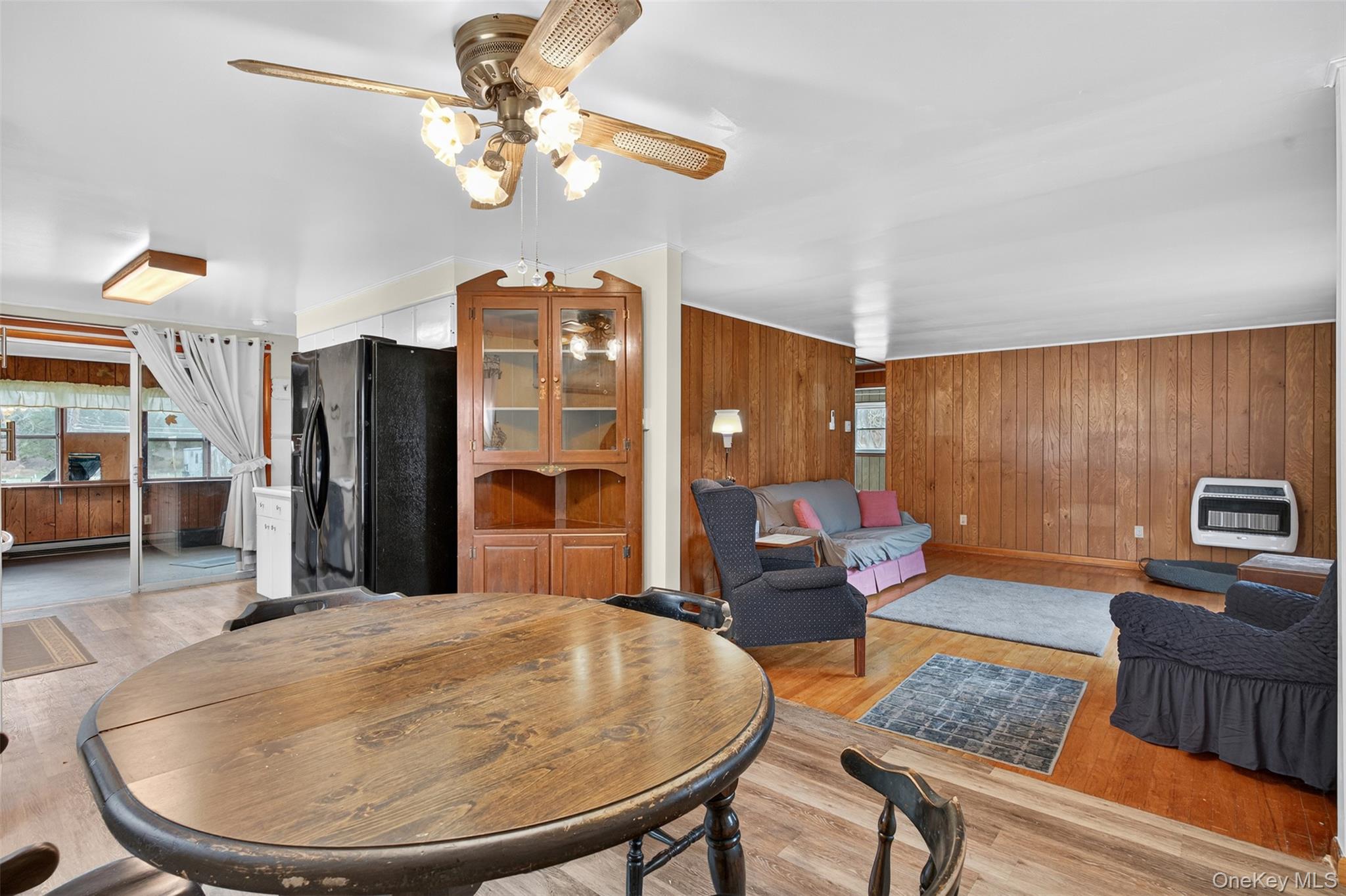 4030 Highway 209, Unit 4028 Stone Ridge, NY 12484 - Photo 7 of 22 a living room with furniture and a chandelier