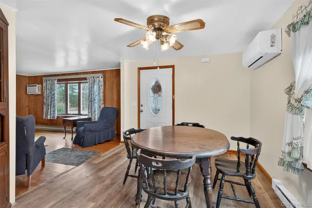 a view of a dining room with furniture and chandelier