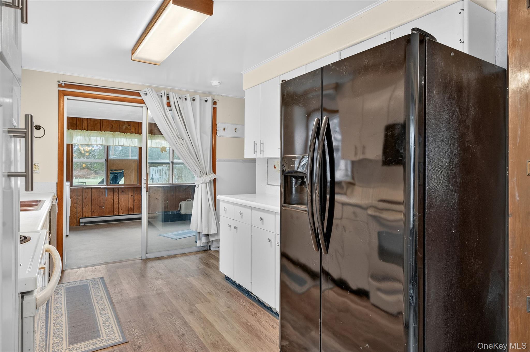 4030 Highway 209, Unit 4028 Stone Ridge, NY 12484 - Photo 9 of 22 a kitchen with stainless steel appliances a refrigerator and a sink