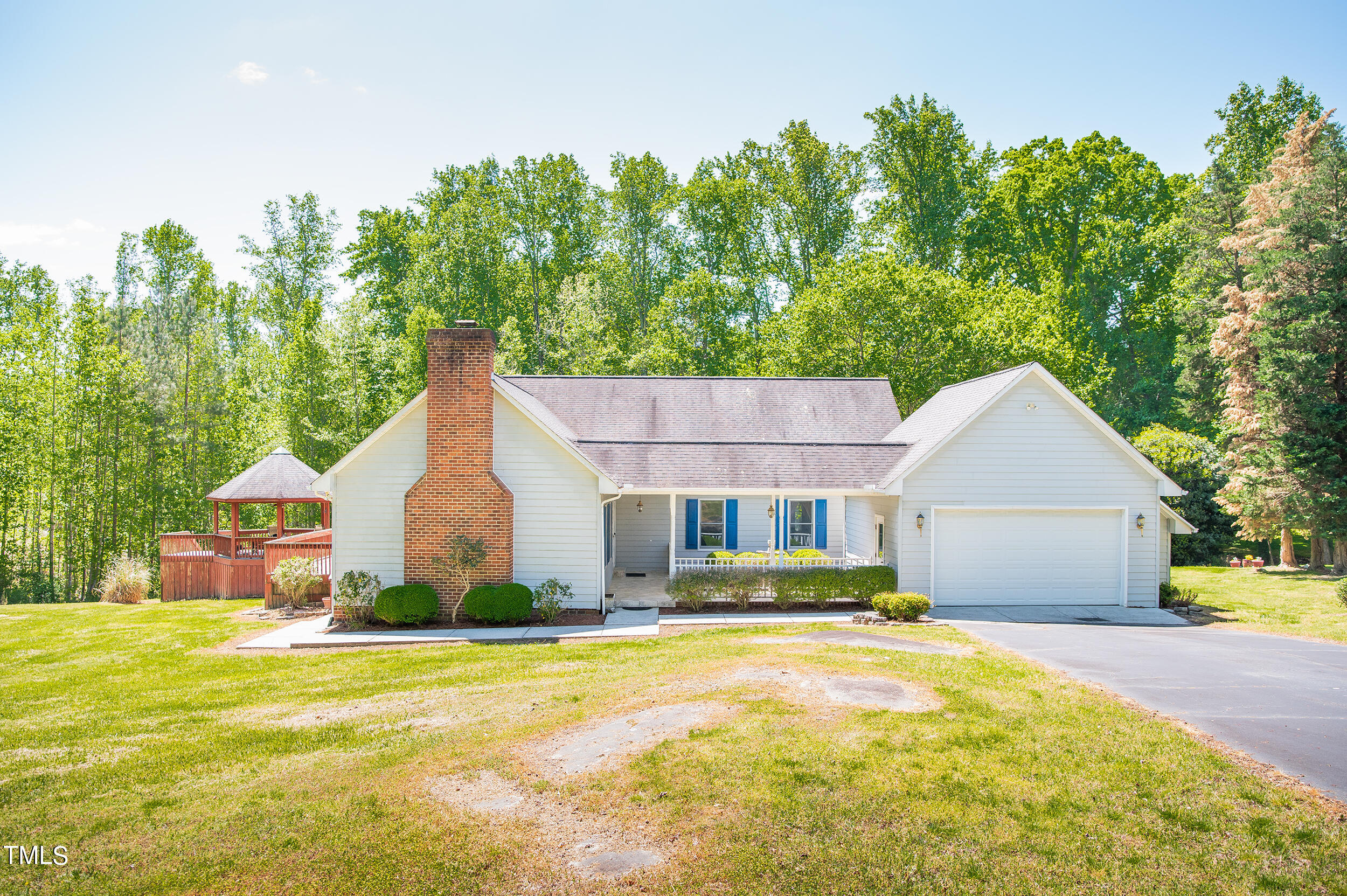a view of a house with pool and a yard