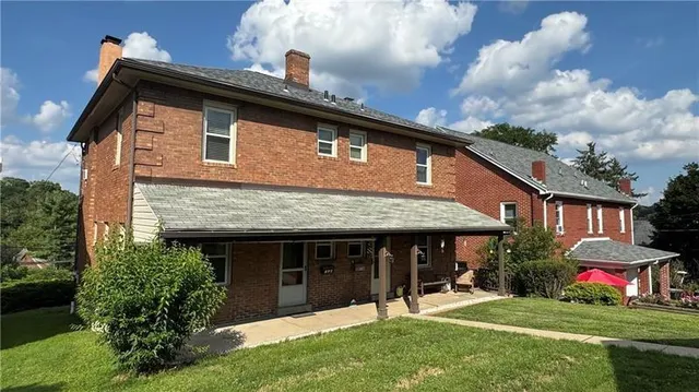 a front view of a house with a yard table and chairs