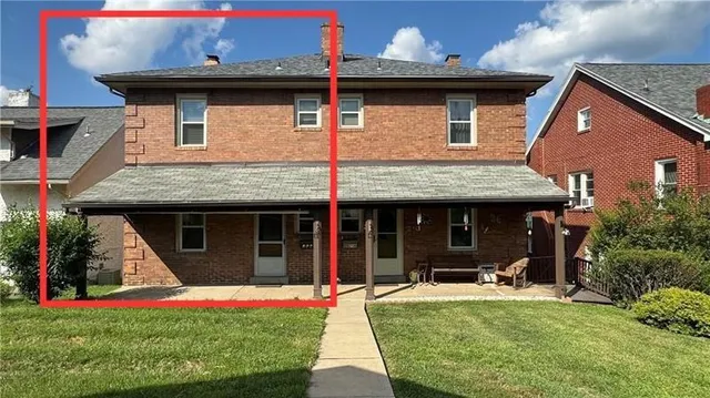 a front view of house with an outdoor seating