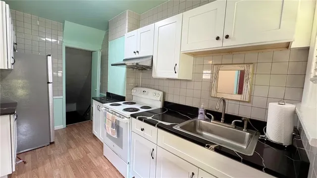 a kitchen with a sink stove and refrigerator