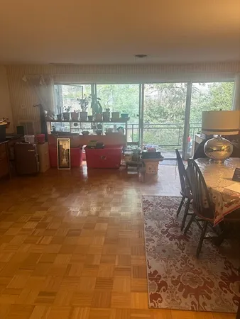 a room with patio furniture and a floor to ceiling window