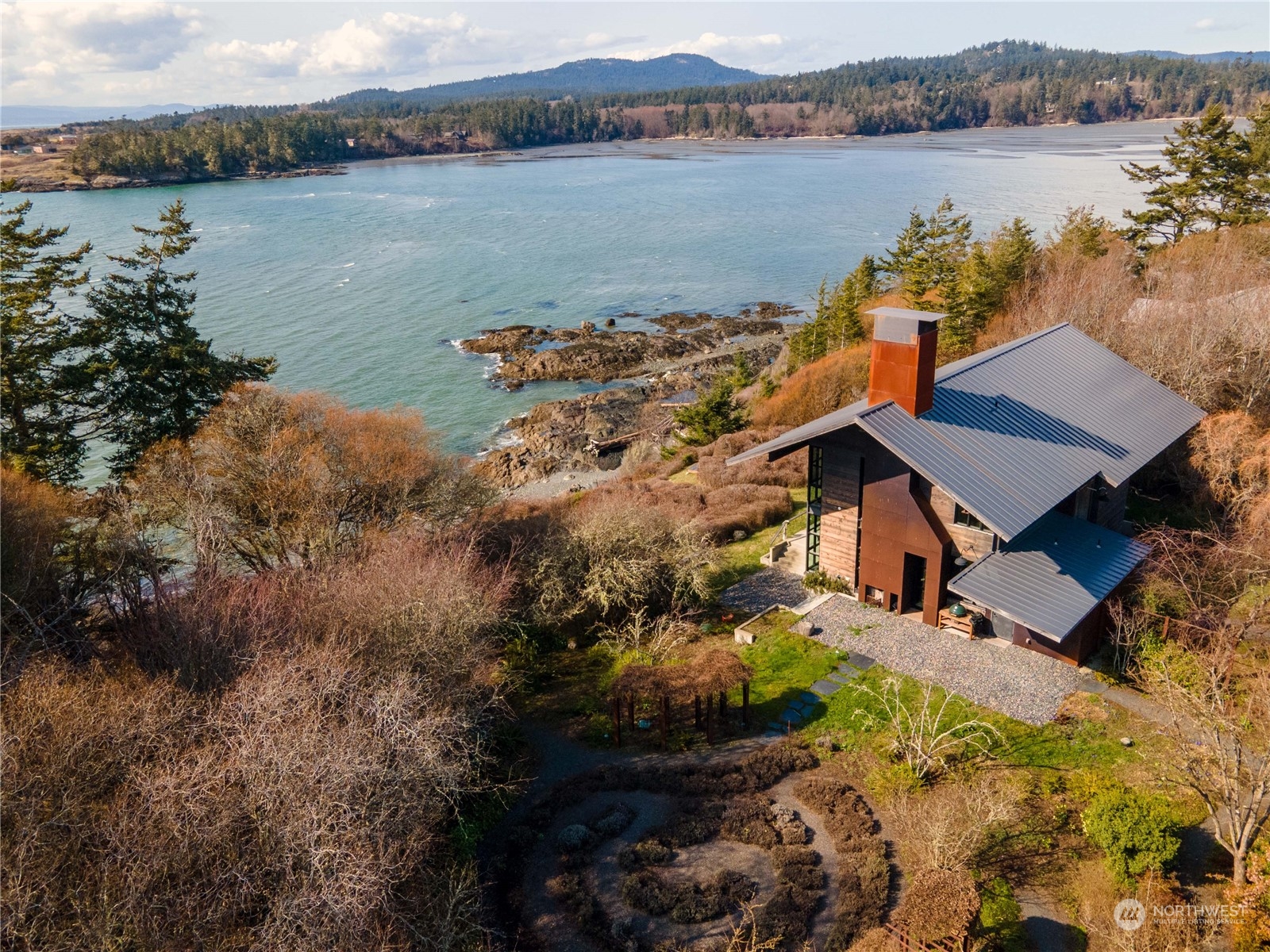 265 Rainshadow Road San Juan Island, WA 98250 - Photo 2 of 40 an aerial view of a house with a lake view