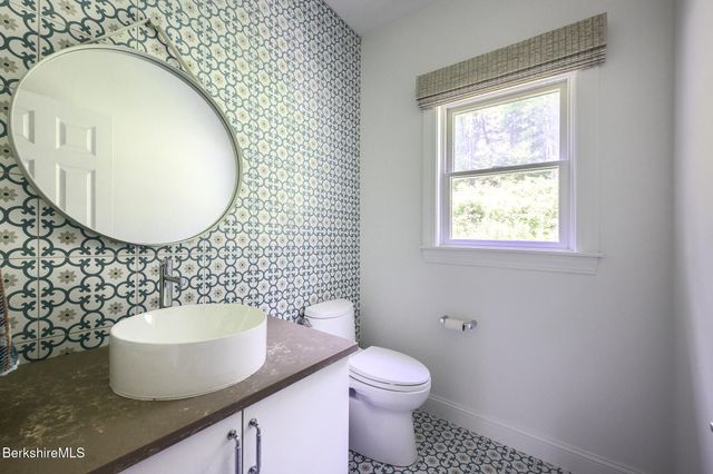 a kitchen with stainless steel appliances kitchen island granite countertop a refrigerator and stove