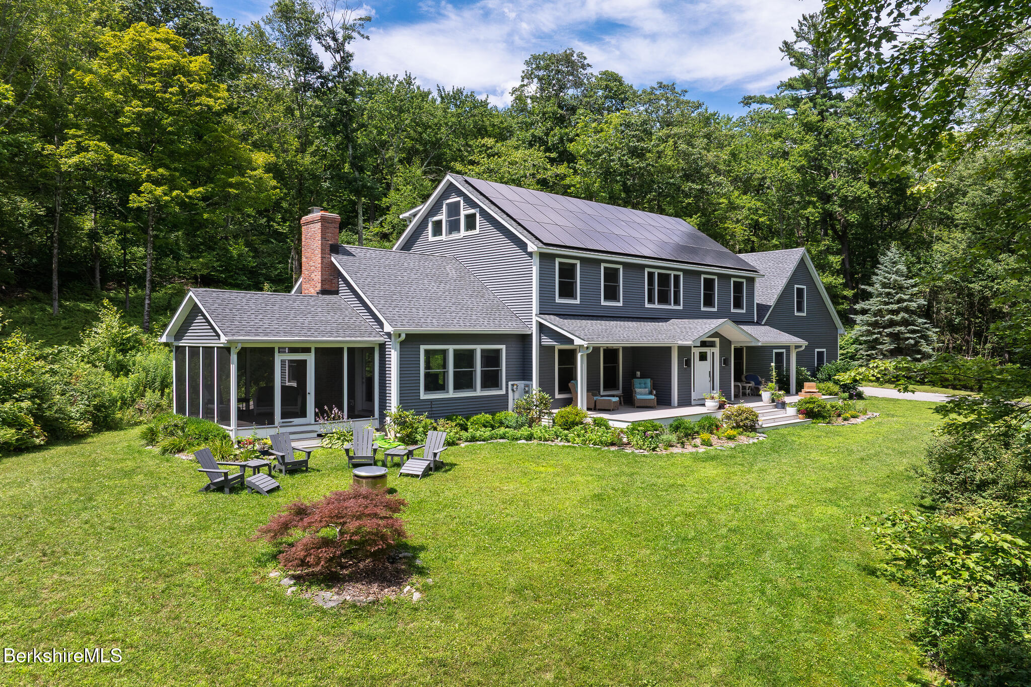 50 Old Village Road Alford, MA 01230 - Photo 2 of 66 a front view of a house with a yard table and chairs