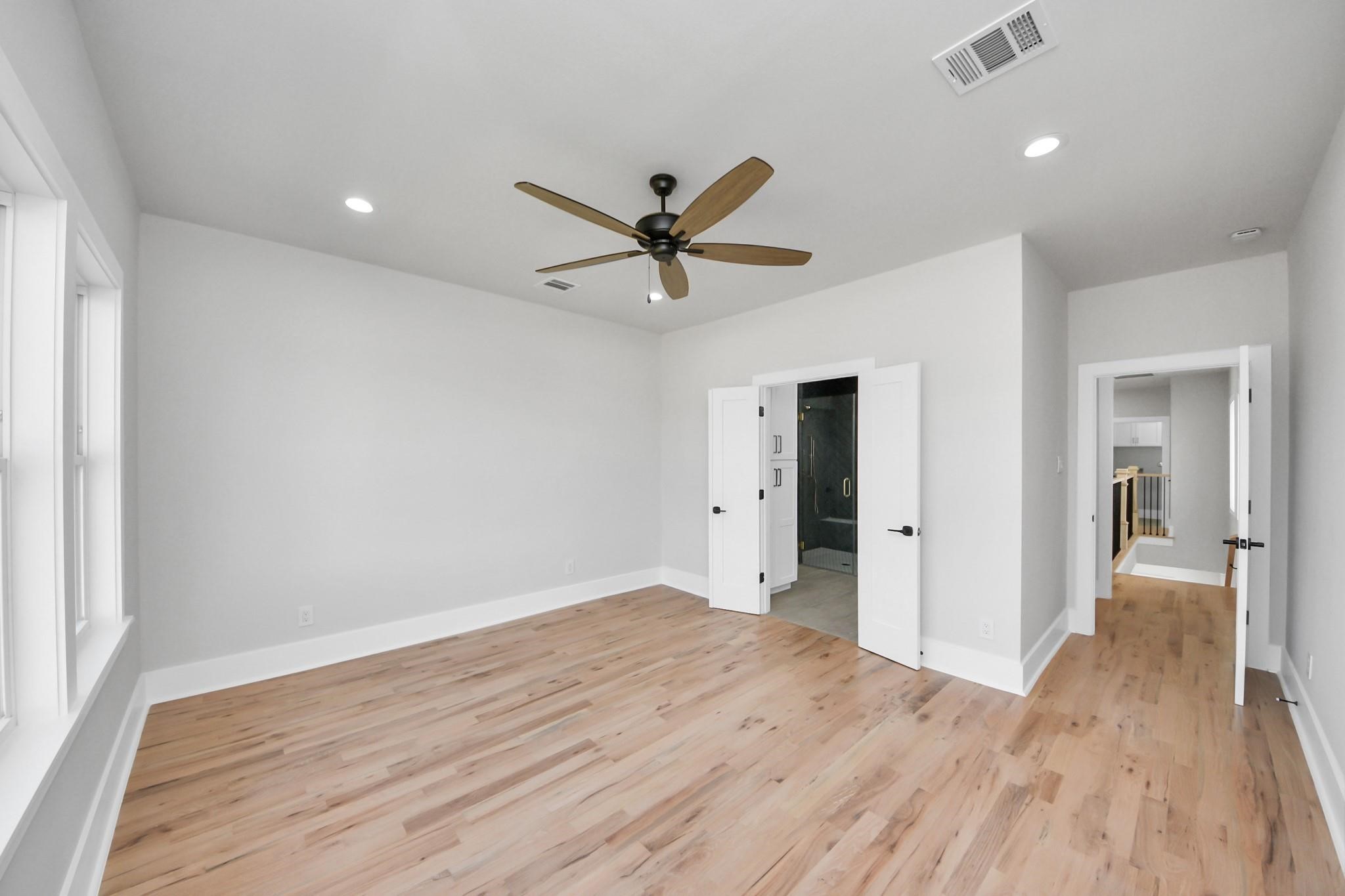 6320 Milwee Street, Unit B Houston, TX 77092 - Photo 18 of 30 wooden floor in an empty room with a window