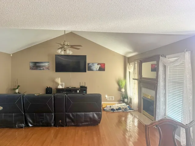 a large kitchen with stainless steel appliances a large counter top a stove a chimney a sink and cabinets