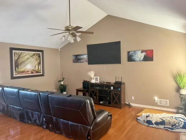 a kitchen with stainless steel appliances granite countertop a stove a sink dishwasher and cabinets with wooden floor