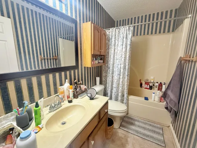 a bathroom with a shower and a sink