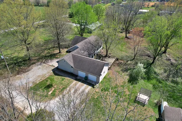 an aerial view of a house with yard