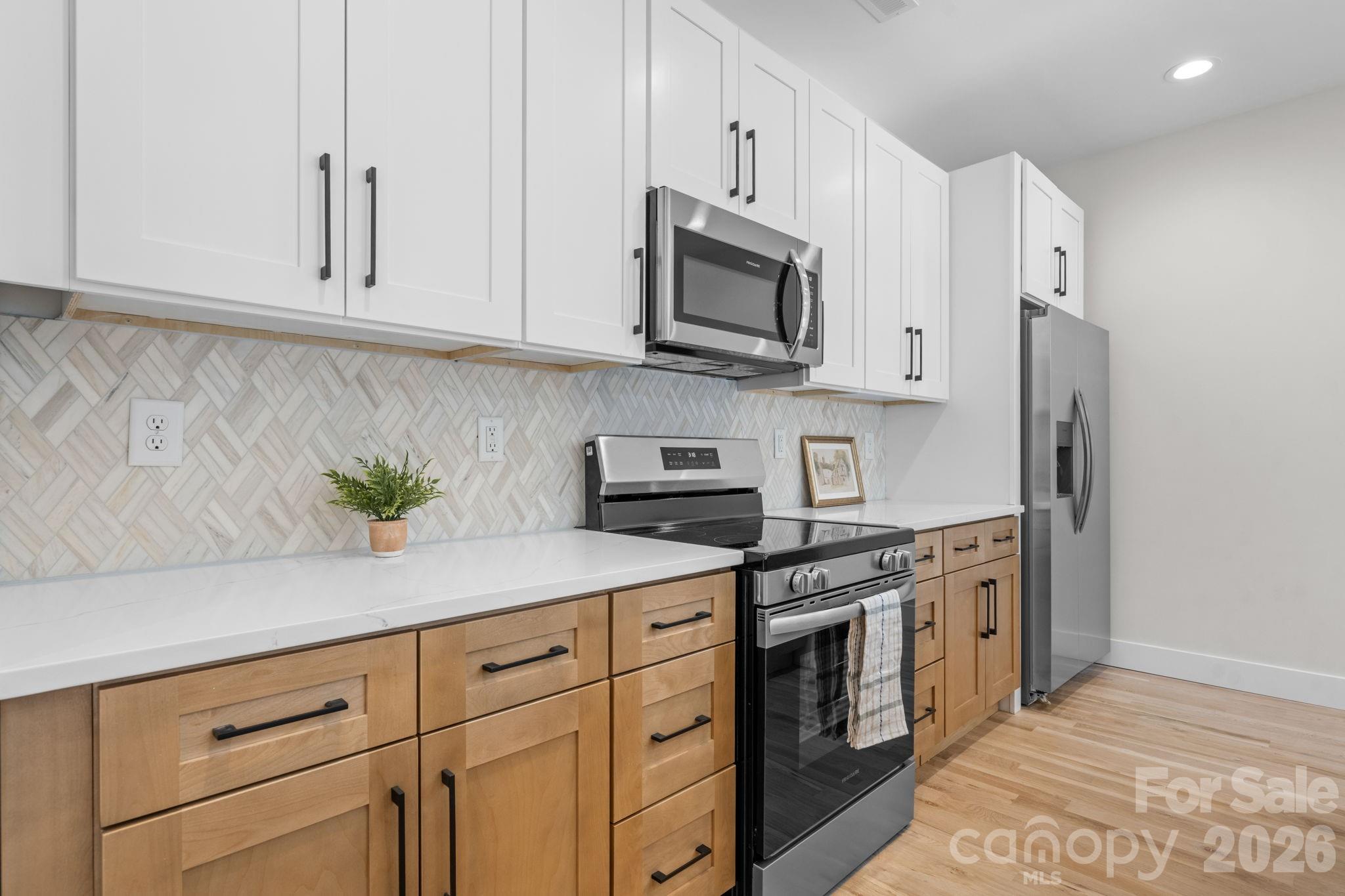 548 Car Farm Road Lincolnton, NC 28092 - Photo 5 of 41 a kitchen with stainless steel appliances granite countertop white cabinets a stove and a sink