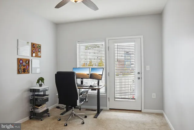 a view of a workspace with furniture and a window