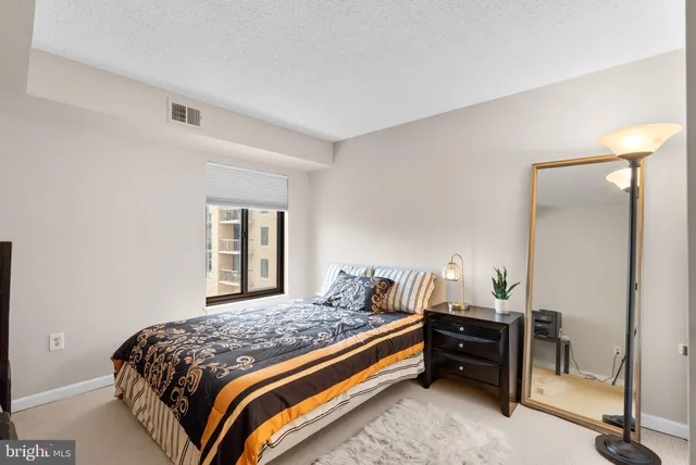 a bedroom with a bed and window