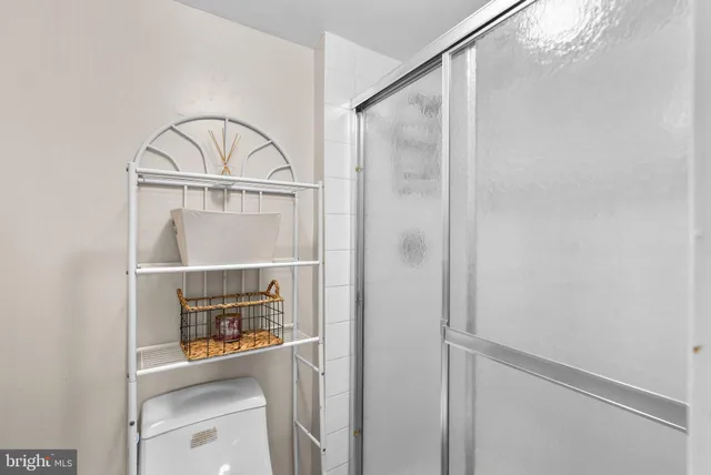 a bedroom with a bed and a night stand