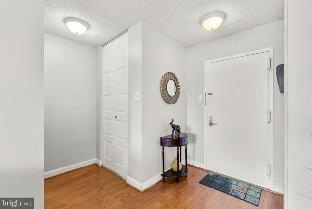 a view of a room with wooden floor