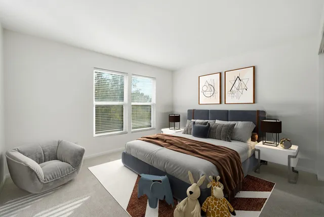 a bedroom with a bed and a couch with window