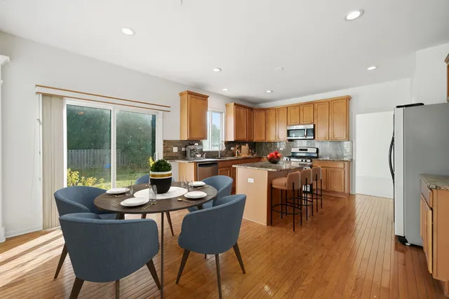 a dining room with furniture and a kitchen view
