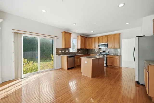 a kitchen with a refrigerator a sink and a stove top oven
