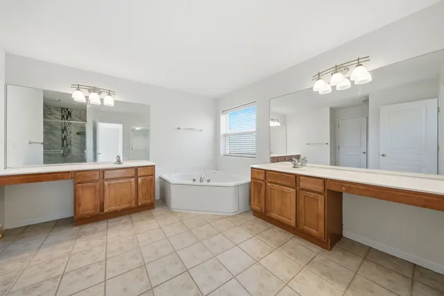 a large bathroom with a large tub sink and double vanity
