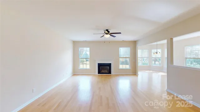 a view of a livingroom with wooden floor and a fireplace