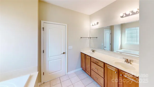 a bathroom with a double vanity sink and mirror with shower