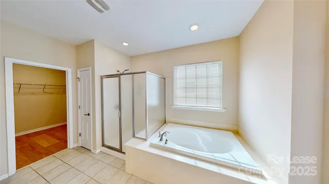 a bathroom with a tub a sink and a shower