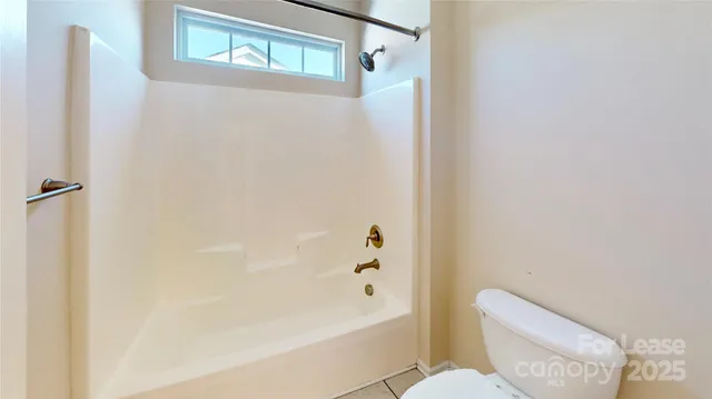 a bathroom with a bathtub and toilet
