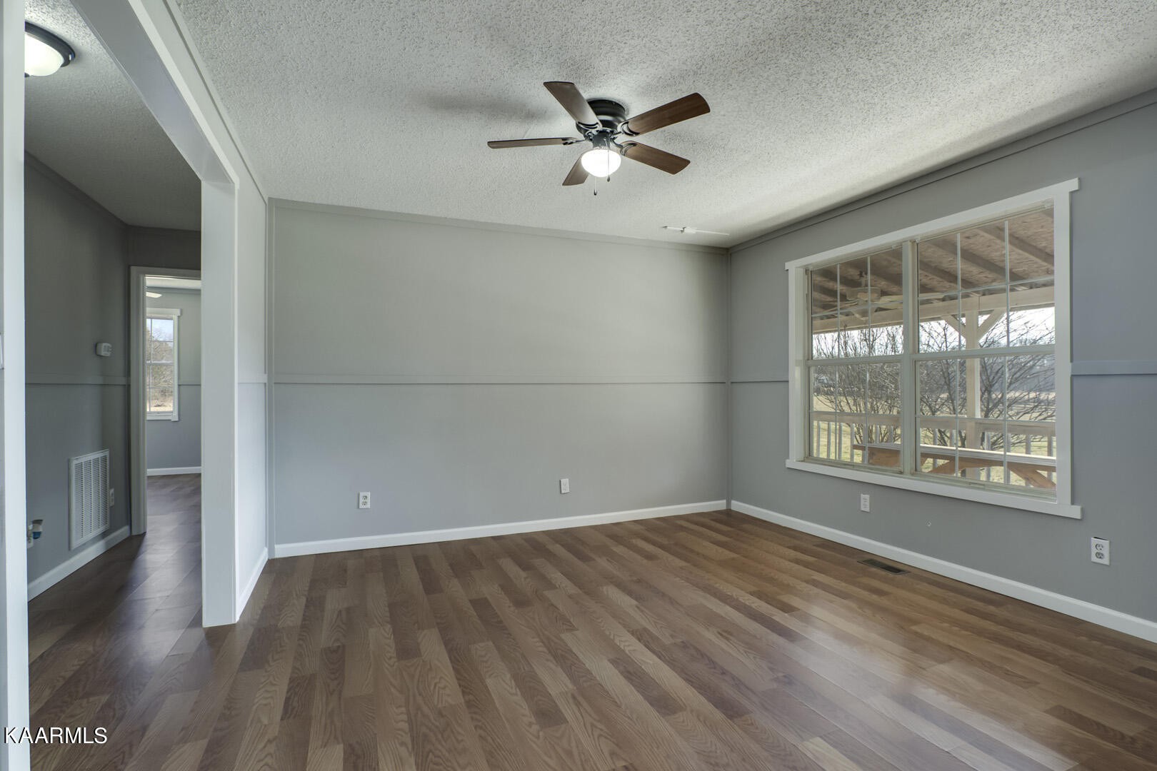 199 Honeysuckle Road Loudon, TN 37774 - Photo 13 of 33 a view of an empty room with wooden floor and a window